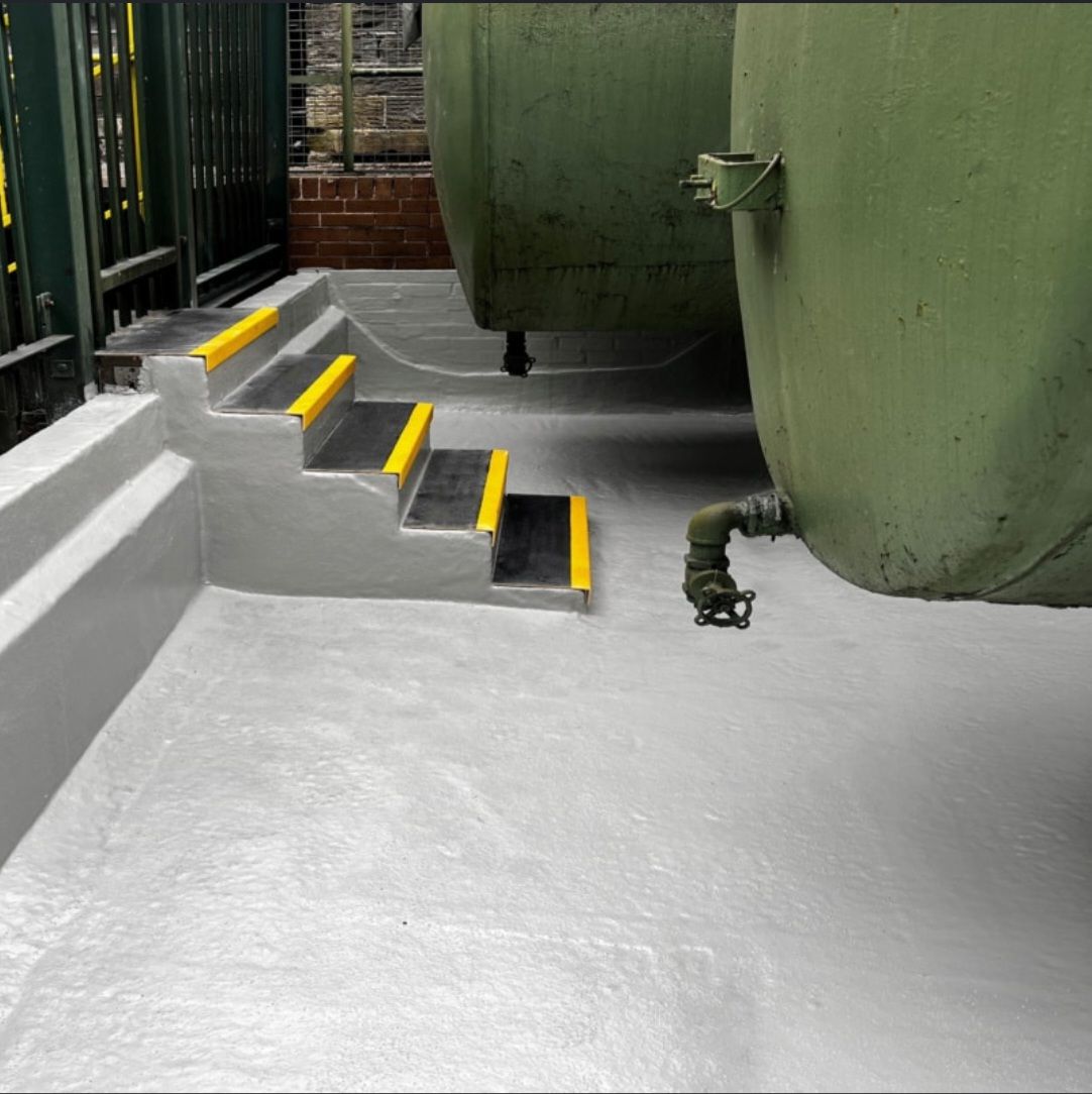 Coated concrete bund floor and steps beneath storage tanks