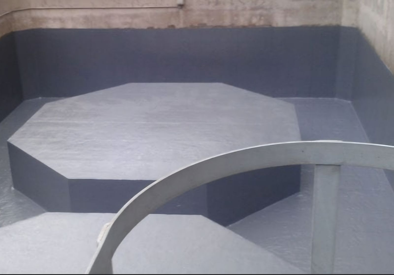 Interior view of a coated concrete bund with raised platform